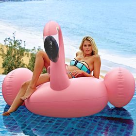 Giant inflatable flamingos ride on floating objects in the swimming pool, equipped with fast valve swimming rafts